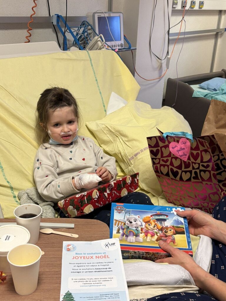 Le Père Noël donne des cadeaux à un enfant hospitalisé